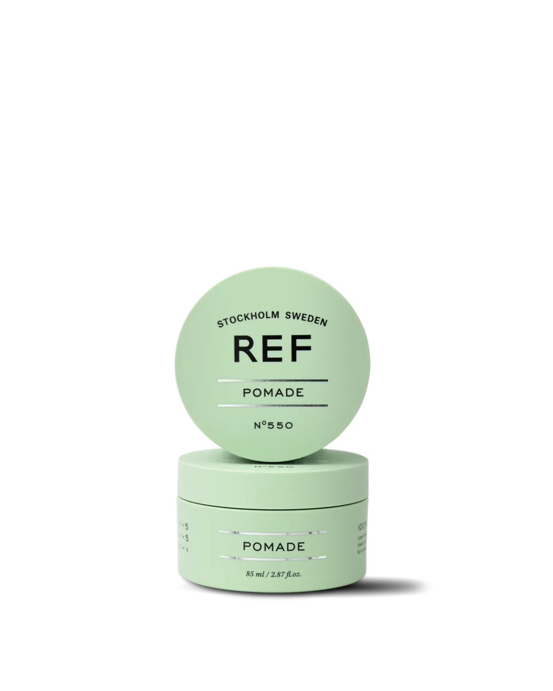 Official REF Stockholm front/hero product shot of Pomade N°550 (85ml) - closed jar with lid propped against the jar, showing the mint-green packaging and REF logo. Source: refstockholm.com official product page (og:image).