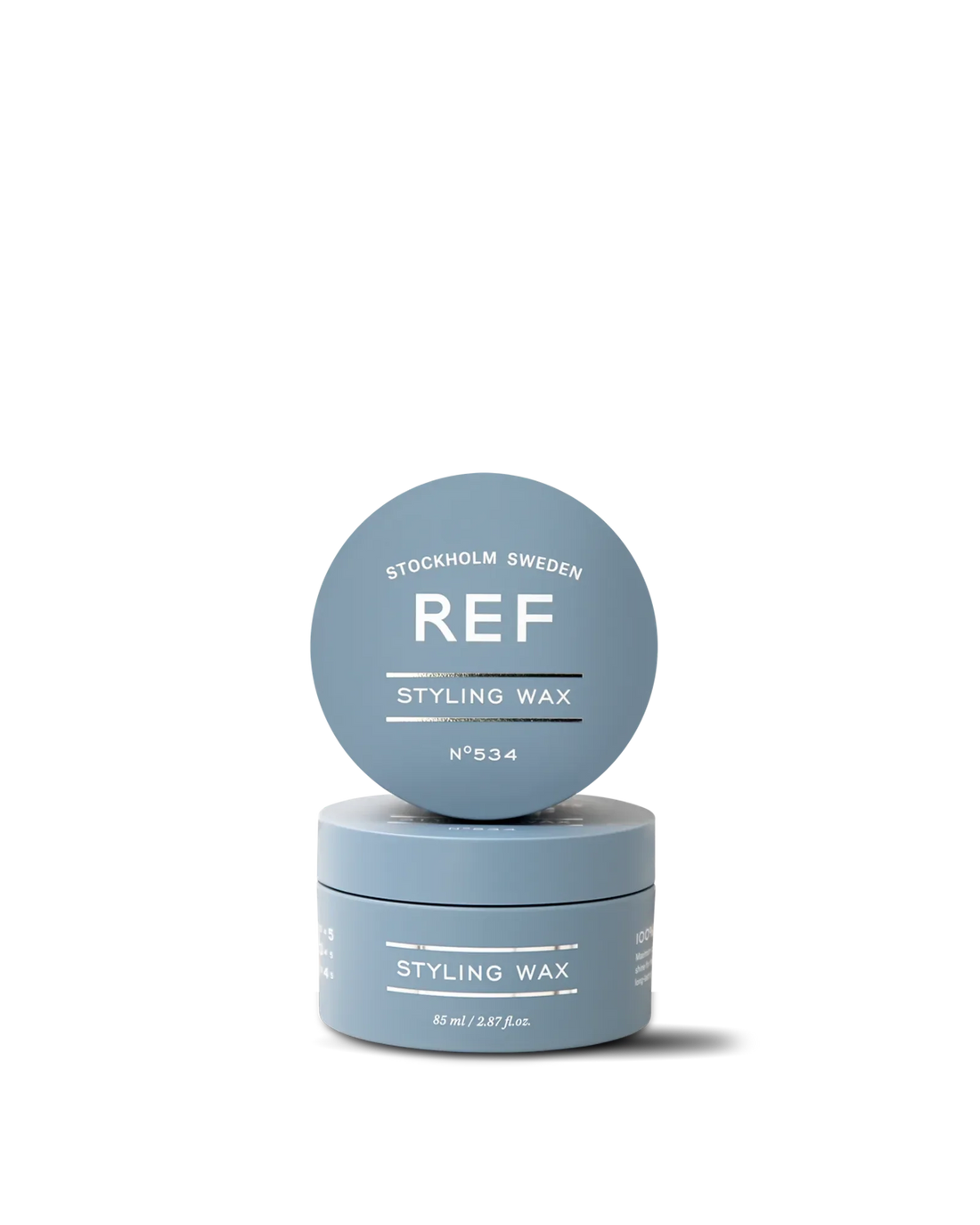 REF Stockholm Styling Wax N°534 (85ml) — official front product shot showing the jar with its lid stacked on top, both printed with the 'REF Styling Wax N°534' label. Source: official REF Stockholm Shopify store product page (refstockholm.com/en-us/products/styling-wax-85ml).